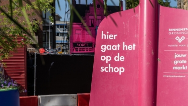 Schep met tekst hier gaat het op de schop